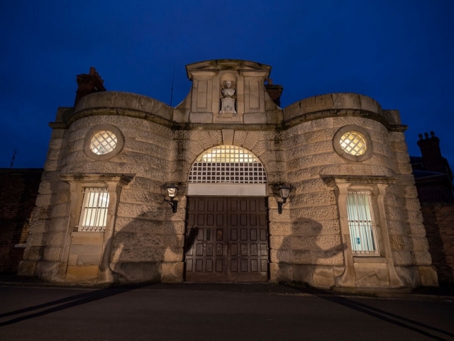 HMP Shrewsbury gatehouse at night with ghost shadows